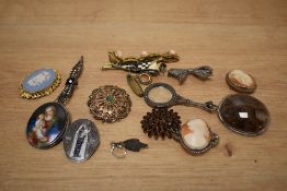 A collection of costume brooches, including a silver set cameo, a marcasite set bow example and a