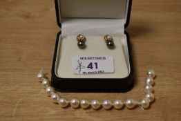 A pair of black pearl stud earrings, mounted on 18ct white gold posts, sold along with a pair of 9ct