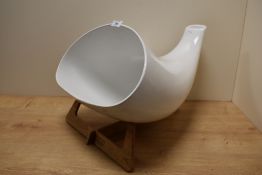 A white porcelain iphone hall speaker with beech standing design, manufacturer label to base, made