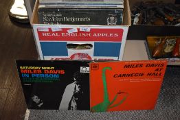 A box containing various records, to include Miles Davis at Carnegie Hall, Miles Davis Saturday