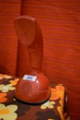 A retro red 'cobra' telephone having push button dial, h22cm