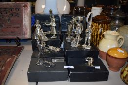 A group of Royal Hampshire Art Foundry silver plated figures and figurines including a flute player,