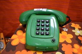 A retro green telephone with large dial buttons, w22cm
