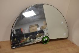 A vintage half moon wall mirror having central green glass aye, w65cm