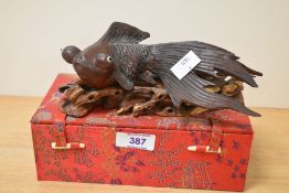 An early 20th century Japanese carved fish of naturalistic form supported on a carved wooden sea bed
