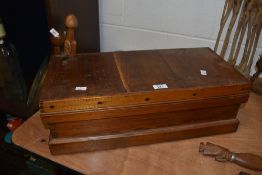 A small pitch pine storage trunk raised upon a stout continuous plinth base, H18cm x L55cm