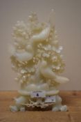 A Chinese carved white stone display having carved branching stems bearing flowers and three birds
