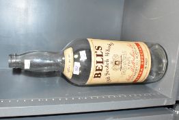 A large early 20th century Bell's Scotch Whiskey glass bottle, impressed makers marks to back,