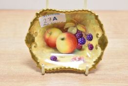 A hand painted Royal Worcester porcelain dish, decorated with fallen berries and peaches against a