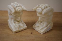 A pair of heavy carved alabaster bookends in the form of satyr's, h14cm