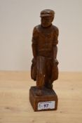 A 20th Century carved oak folk art study of a fisherman and his catch, signed 'W.Lang' for Wharton