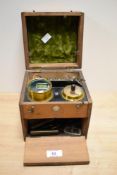 An early 20th century cased System Vogt electrotherapy machine, having retailers label for A