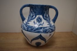 A reproduction two handled vase having blue floral patterns on a white ground, baering marks to base