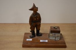 A rare early 20th century folk desk stand with soldier and glass inkwell, L20cm