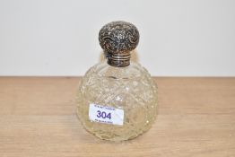 A Victorian silver capped cut glass scent bottle having a silver top lid of globular form, h12cm