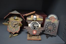 A vintage Swiss Chalet Cuckoo Clock (damaged), w9cm, sold together with two similar Swiss