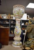 A large ceramic jardiniere having floral design to white background with off red detailing,