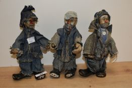 A group of three pottery clown/hobo figures, each dressed in denim, 20cm