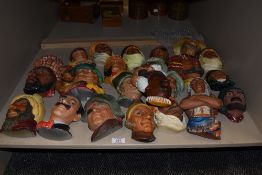 A large assortment of vintage cast chalk bosson heads depicting pirates and sailors etc.