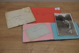 A mid 20th century autograph book, containing various signatures, sold along with a signed cricketer
