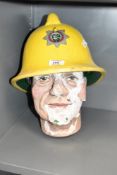 A lifelike chalk bust wearing yellow fireman hat for Cumbria Fire Service, h35cm