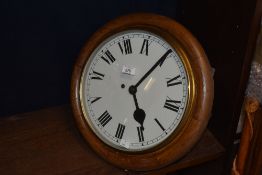 A late 19th / early 20th century fusee wall / station clock, having turned oak surround, Roman dials