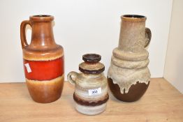 A West German ceramic vase decorated with a red drip glaze on a brown ground, impressed pattern