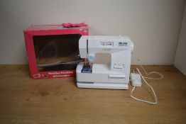 A modern Childs Zig-Zag Lockstitch Battery Operated Sewing Machine, 6+, in window display box