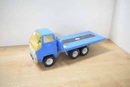 A Tonka pressed steel Six Wheel Flat Bed Truck, blue with white interior