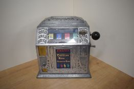 A vintage Penny One Armed Bandit, Pilgrim Chocolate Rock Chewing Gum, Match 3 numbers to win, in