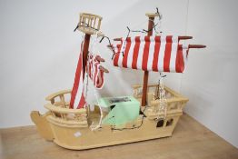 A Modern ELC Wooden Pirate Ship with sails and plastic accessories, height 52cm, length 65cm