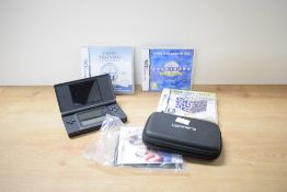 A Nintendo DS Lite, serial number UEH16694434 in soft case with instructions and three games, The