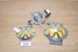 Two AA badges 60214106 and 66968Y and a Civil Service Motoring Association badge