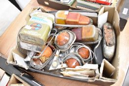 A box of vintage light fittings, badges etc