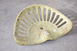 A vintage agricultural implement cast metal seat from H Bamford & Sons