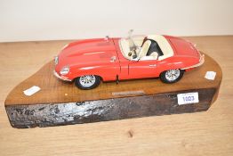 A model 1961 Jaguar XKE Roadster on wooden plinthe