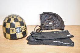 An early 20th century Norton chequer board crash helmet, leather helmet and a pair of leather bike