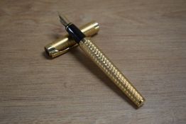A Waterman L'Etalon converter fill fountain pen in Gold Plated chequer plate design having