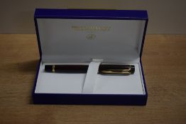 A boxed Waterman Liaison cartridge converter fountain pen in red woodgrain ebonite with gold trim