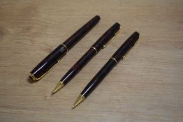 A Parker Sonnet converter fill fountain pen and two propelling pencils in Laque Firedance having