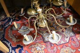 A brass ceiling light fitting having eight branch candle effect