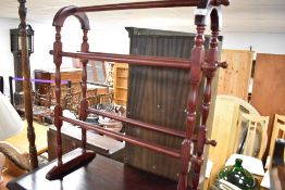 A reproduction stained frame towel rail