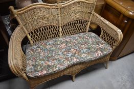 A wicker conservatory settee