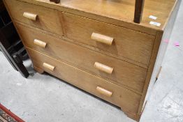 An early to mid 20th Century golden oak bedroom chest of two over two drawers, in the Gomme style,