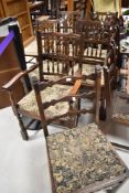 A set of five traditional dark stained spindle back dining chairs having drop in seats and a set