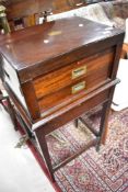 An early 20th Century mahogany canteen of cutlery on stand, in the campaign style , knife blades