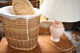 A modern ceramic table lamp and a selection of wicker baskets