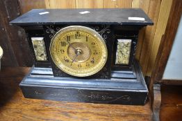 A Victorian black slate and metal mantel clock, having gilt face