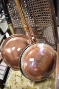 Two vintage warming pans and a copper horn