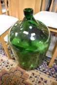 A large green glass carboy/demijohn style bottle